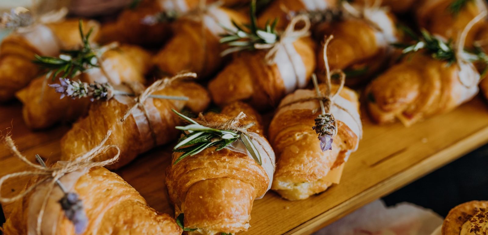 a wooden table topped with lots of pastries